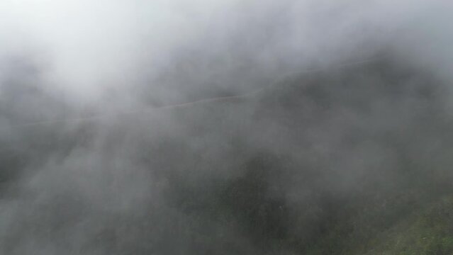 Aerial flight through cloud to famous Death Road in Bolivia mountains