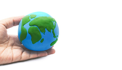 Globe model in hand with copy space on white background. Sustainability and Preservation. World environmental concept. Save the planet earth.