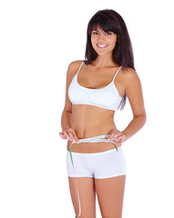 Fototapeta premium Woman, body and measure tape in studio for fitness, health and weight loss results of training progress. Portrait of model or person check stomach for exercise or workout goals on a white background