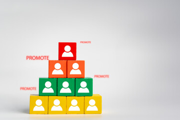 Ascend the corporate ladder with wooden blocks featuring promotion icons, signifying personnel promotion in the organization. Embrace career development and seize job opportunities