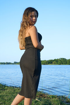 black dress, latina with blue sky and posing next to the lake 03