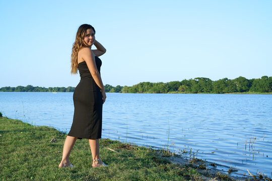 black dress, latina with blue sky and posing next to the lake 02