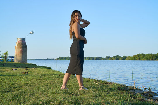 black dress, latina with blue sky and posing next to the lake 01