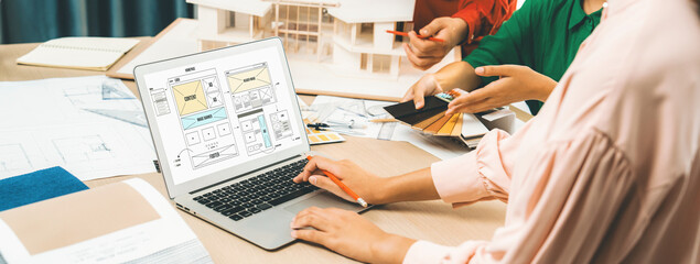 Cropped image of interior designer team discuss the material color while laptop displayed website...