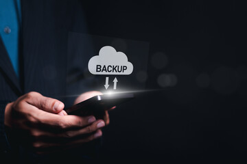 Backup storage data technology concept. Backup online documentation database and digital file storage system or software,file access, doc sharing. Person use smartphone with virtual backup icons.