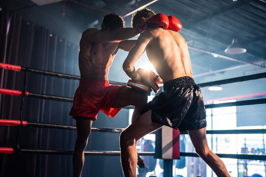 Two young professional boxer having a competition tournament on stage. 