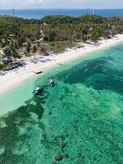 views from the air of a paradisiacal beach with palm trees and lighthouse