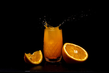 Splashes of orange juice on black