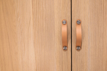 Wooden Closet doors close up background texture modern design. Cozy apartment details. Closet usage.