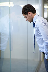 Man, business and leaning on glass wall with stress for financial deal failure or company, mistake or frustrated. Male person, unhappy and career error in New York building, burnout or overwhelmed