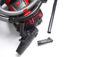 Red vacuum cleaner with attachments on a white background