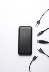 External battery power bank with many cables on a white background