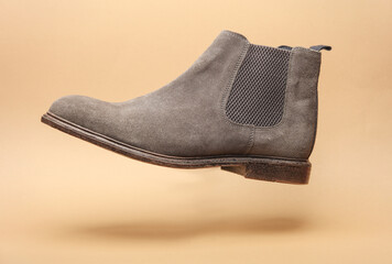 Chelsea boot floating on beige background