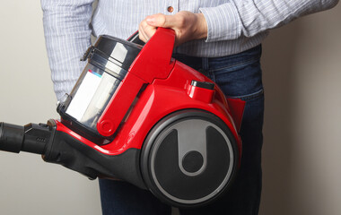 Man holding vacuum cleaner on white background