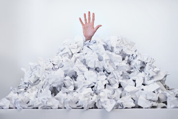 Person, hand and paper pile or trapped in deadlines for work responsibilities for overwhelmed,...