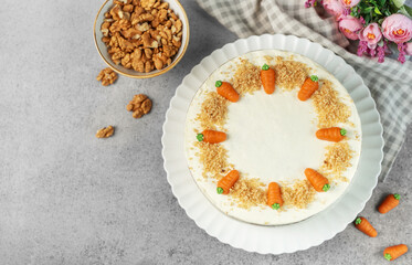 Homemade carrot cake made with walnuts, iced with cream cheese. Sweet dessert.