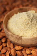 Fresh almond flour in a  bowl and almonds