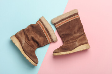 Children's suede boots with fur on a blue-pink background