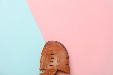 Leather sandal on a blue pink background