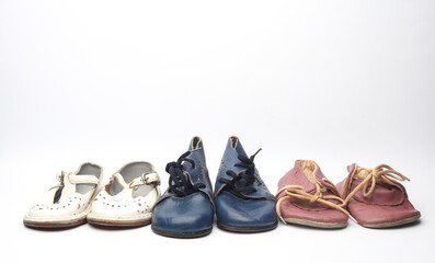 Fototapeta premium Children's retro used shoes on a white background