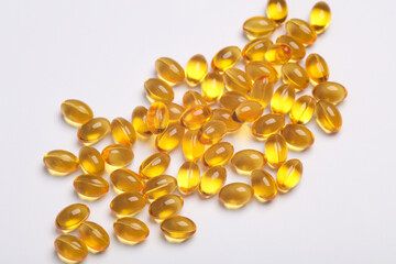 Fish oil capsules on a white background.