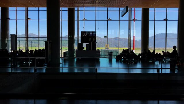 Silhouettes of people waiting for plane in airport departure. Dalaman, Turkey