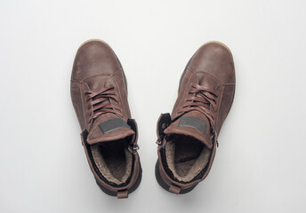 Pair of Brown leather boots on white background. Top view