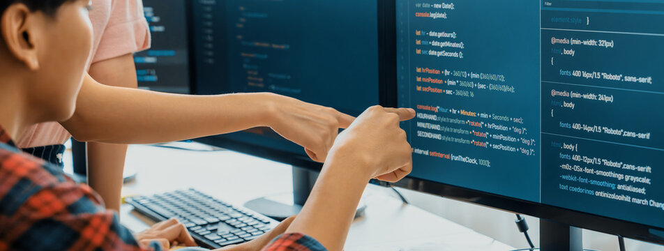Cropped image of professional programer team collaboration discuss about web coding while coworker point java script displayed on computer at modern company office. Closeup. Burgeoning.