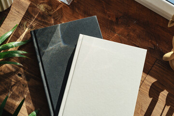 Books by the window on wooden windowsill in sunlight