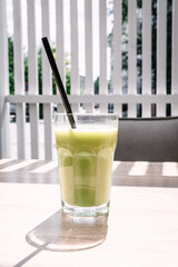 Cold matcha tea on a table in a cafe. Summer cold drinks.