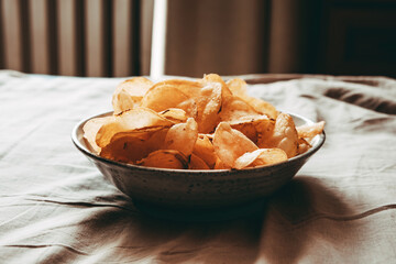 Potato Chips in a bowl for a snack on the bed.
