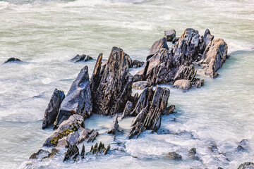 Sharp rocks sticking out of the water in a river