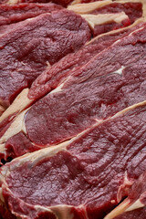 A fresh piece of beef steak on a cutting board