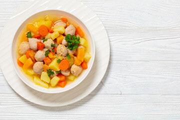 finnish sausage soup with vegetables in white bowl
