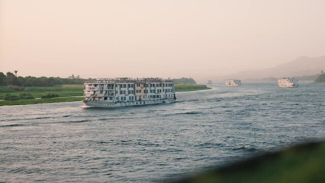 A convoy of cruise ships travelling down the Nile river.