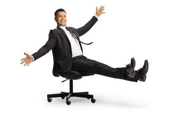 Happy businessman spinning on an office chair
