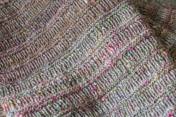 Beautiful handknit sweater, cardigan work in progress on round knitting needles, knitting pattern made with pure organic handspun sheep wool yarn from a traditional spinning wheel	