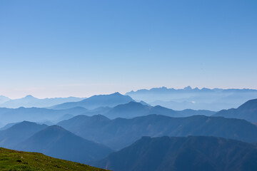 Panoramic view of magical mountain peaks of Karawanks and Julian Alps seen from Goldeck, Latschur...