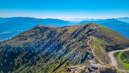 High alpine road to mountain resort Goldeck, Latschur group, Gailtal Alps, Carinthia, Austria. Looking at magical mountain peaks of Karawanks and Julian Alps seen from, EU. Austrian Alps in summer