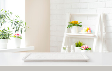 Marble podium tray on white table and blurred room interior background decorated for easter holiday