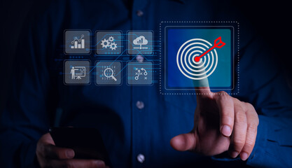 Target business idea Businessman uses smartphone with virtual target icon for business purposes. Strategic planning for business growth and target customer groups