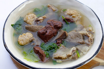 Bowl of pork blood soup on white background.