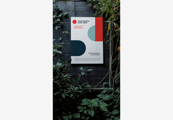 Outside Street Poster Mockup: White Square Hanging on Garden Wall with Plants and Trees, Window, and Brick Background