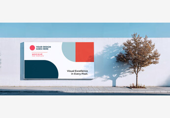 Outdoor Street Poster Mockup: White Wall with Tree, Sidewalk, Blue Sky, and Clouds. Outside Street Poster Template