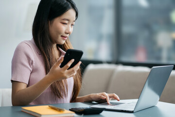 Women work on laptop on the table at the office with information documents.