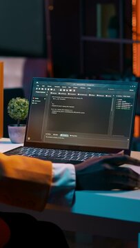 Vertical Video African american it specialist working with coding language and infographics, improving server security on terminal window. Young programming student learning to use code and hardware