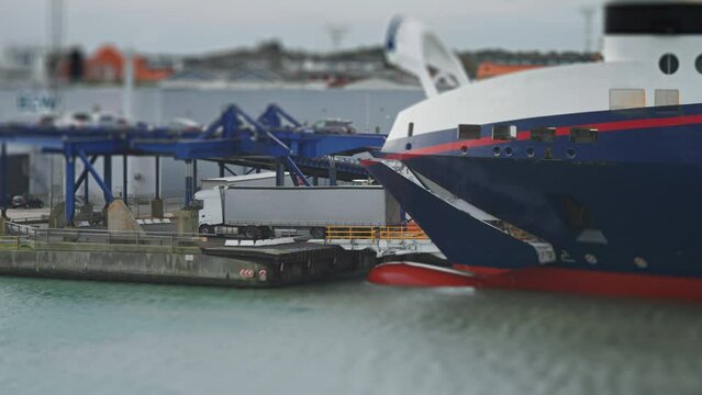 Cars and trucks disembark from the ferry in the Hitshals port.