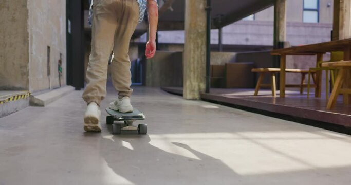 Young man enjoys riding a skateboard.