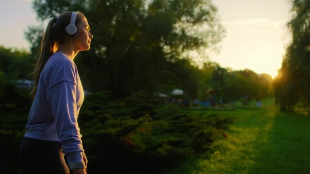 Young woman rollerblading in the park during sunset
