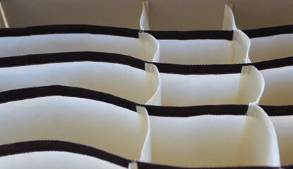 Colorful curved fabric linen drawer compartments 
